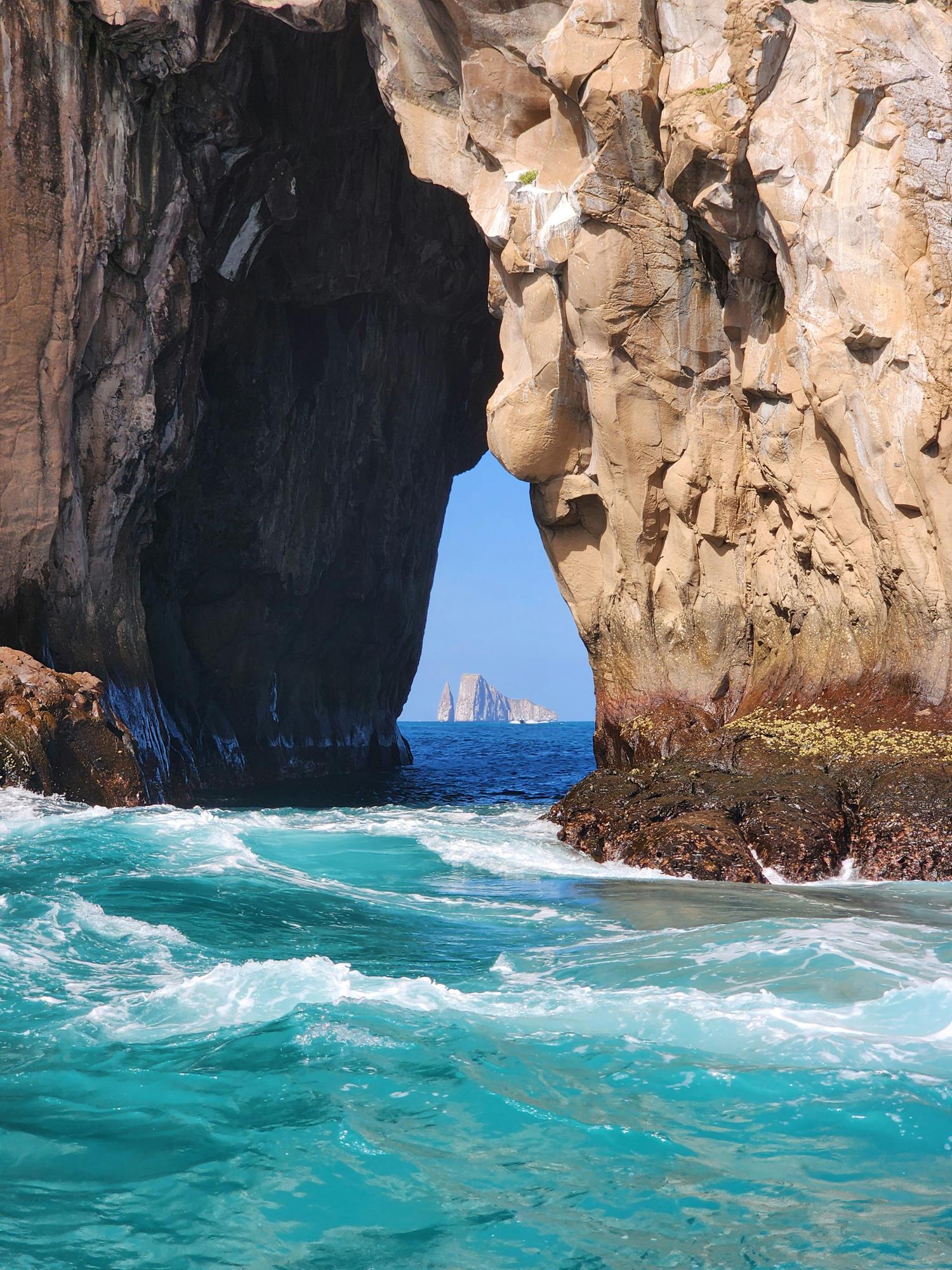 view through a rock at another rock in the ocean